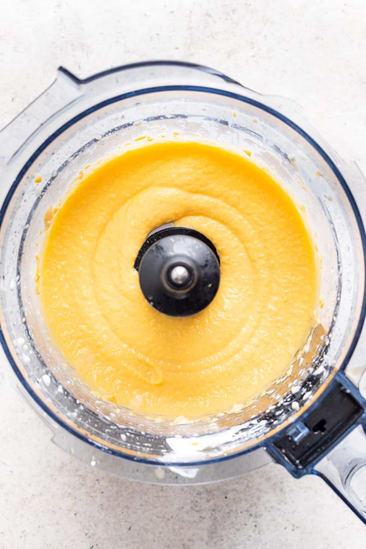 Homemade mango sherbet in a food processor.