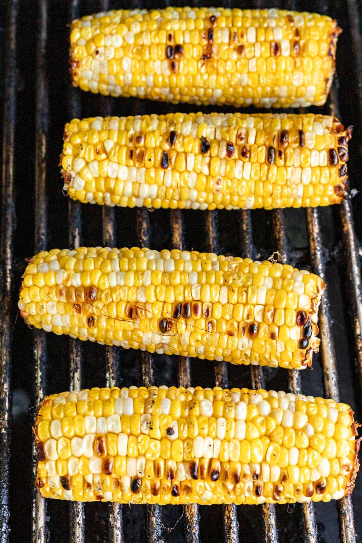 Charred corn on the cob on a grill.