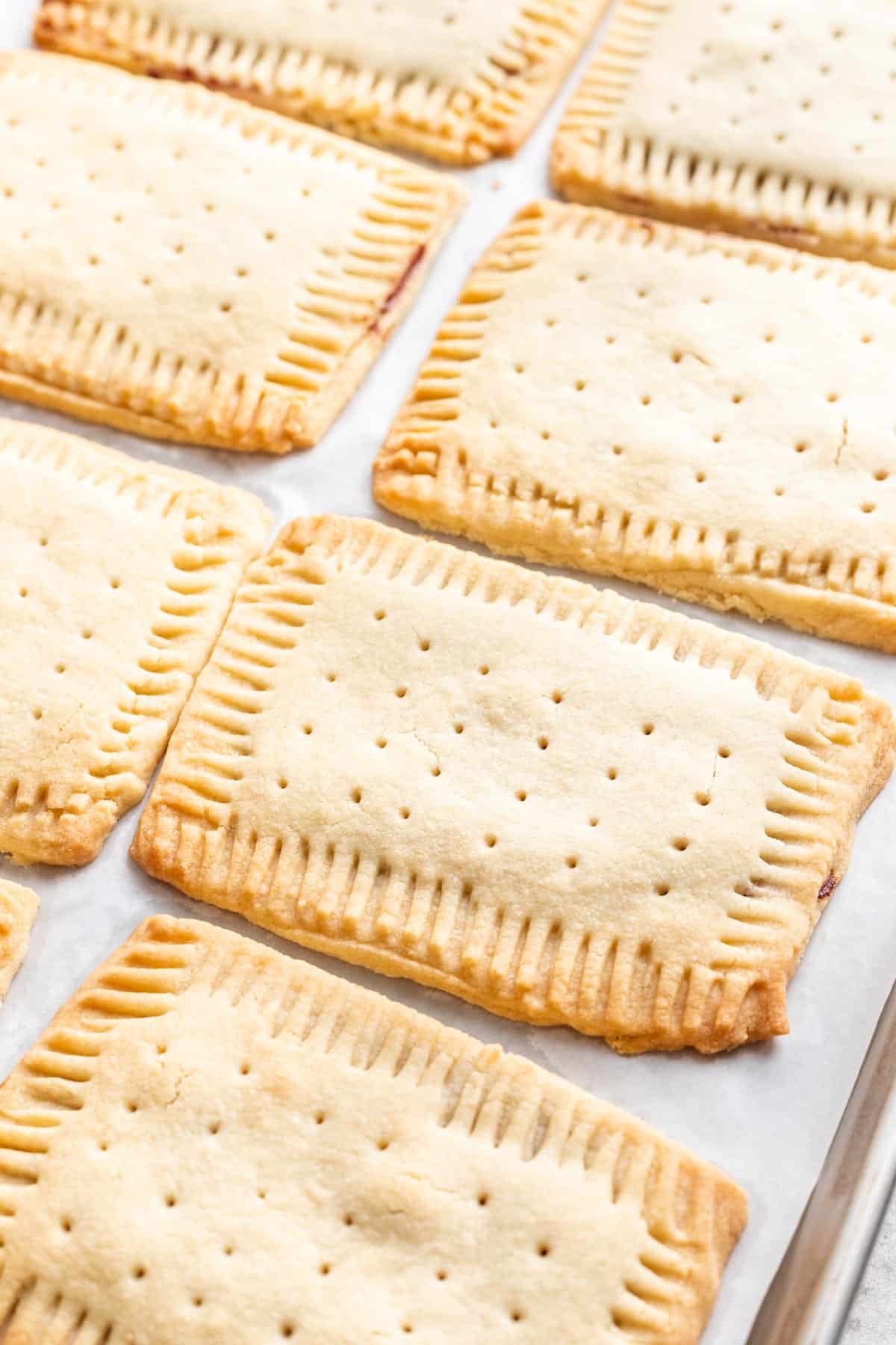Baked pop tarts on a baking sheet without glaze.