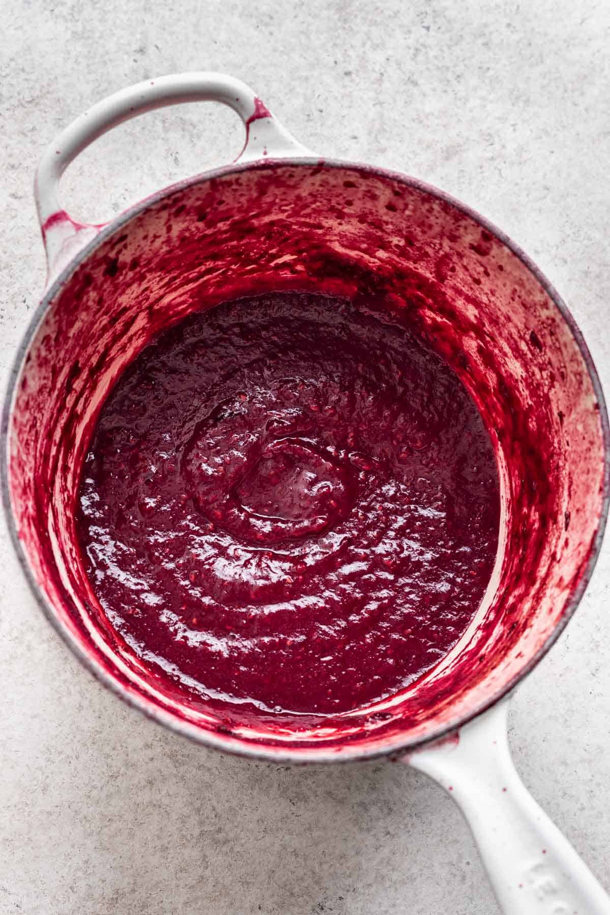Wild berry filling cooked until thick in a saucepan.