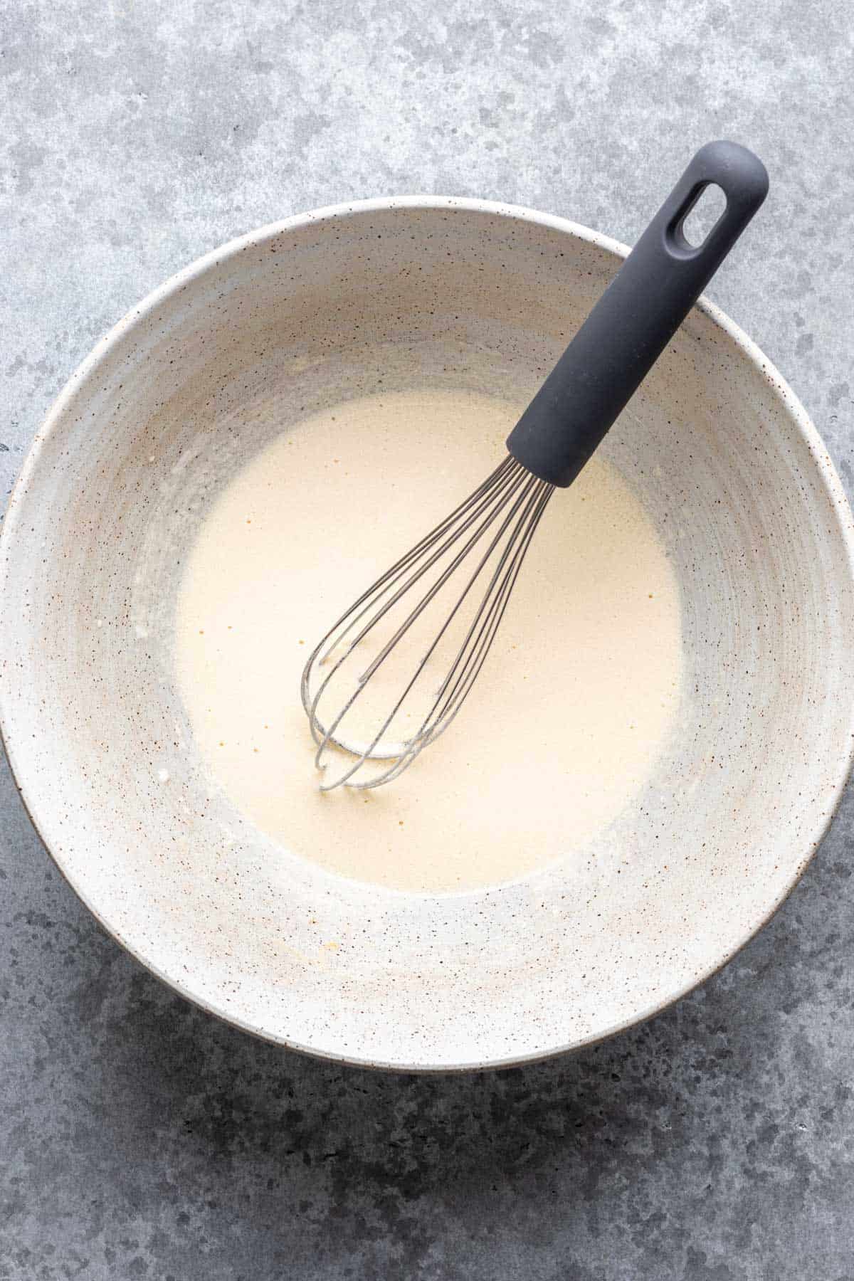 Liquid ingredients mixed together in a large bowl.