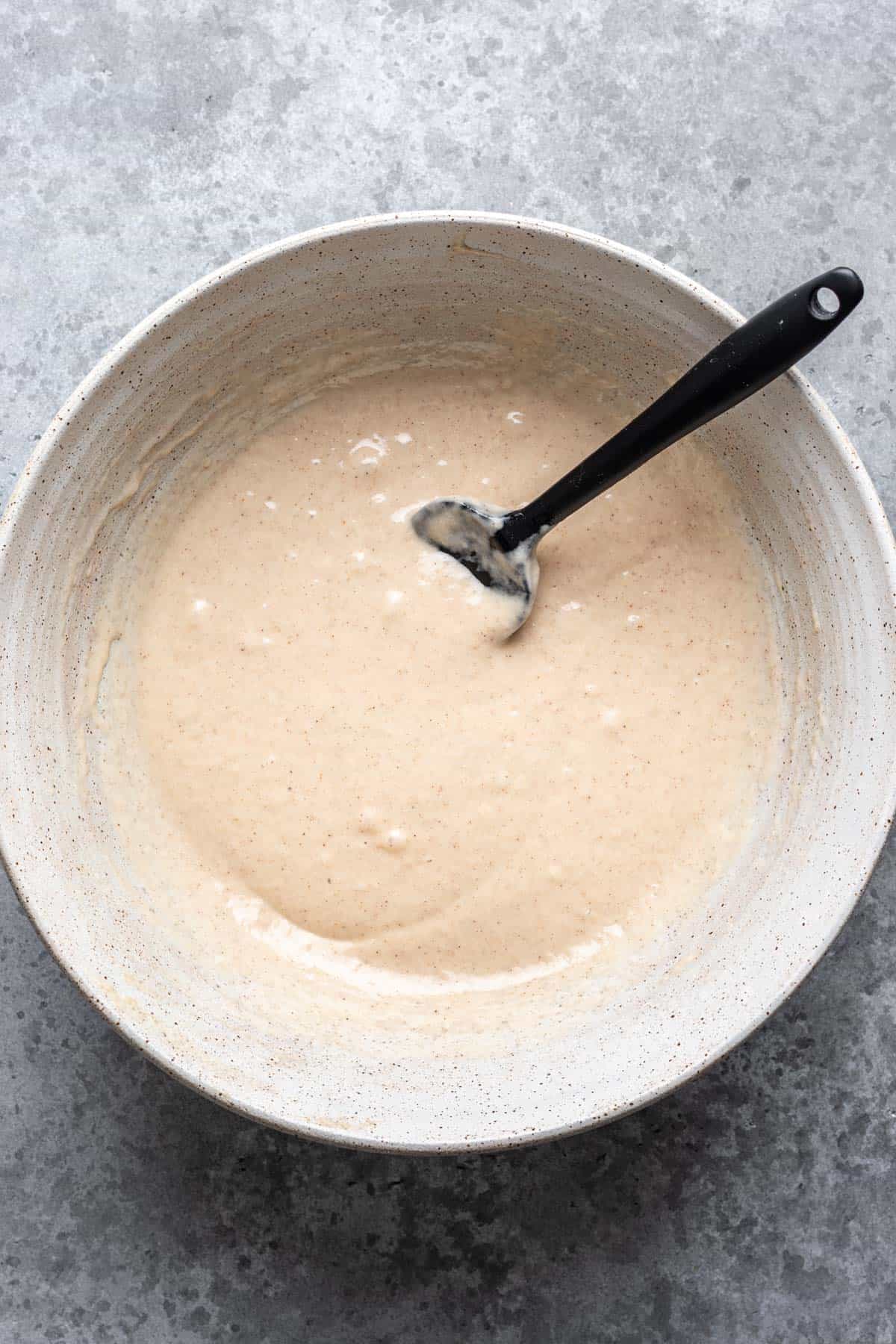 Wet and dry ingredients mixed in a large bowl.