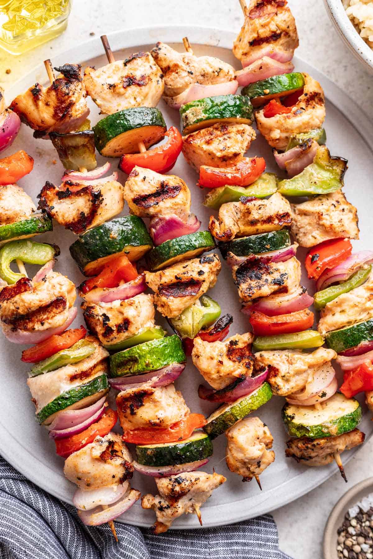 Greek yogurt marinated chicken on kebabs with vegetables.