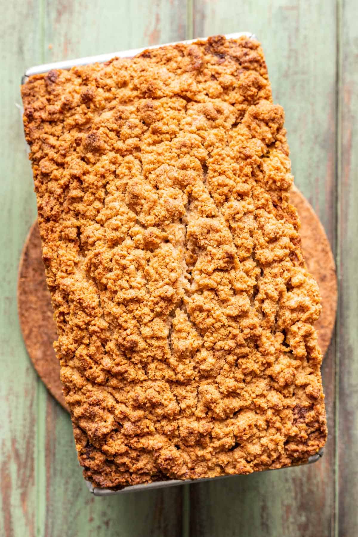 Baked apple pumpkin bread in a loaf pan.