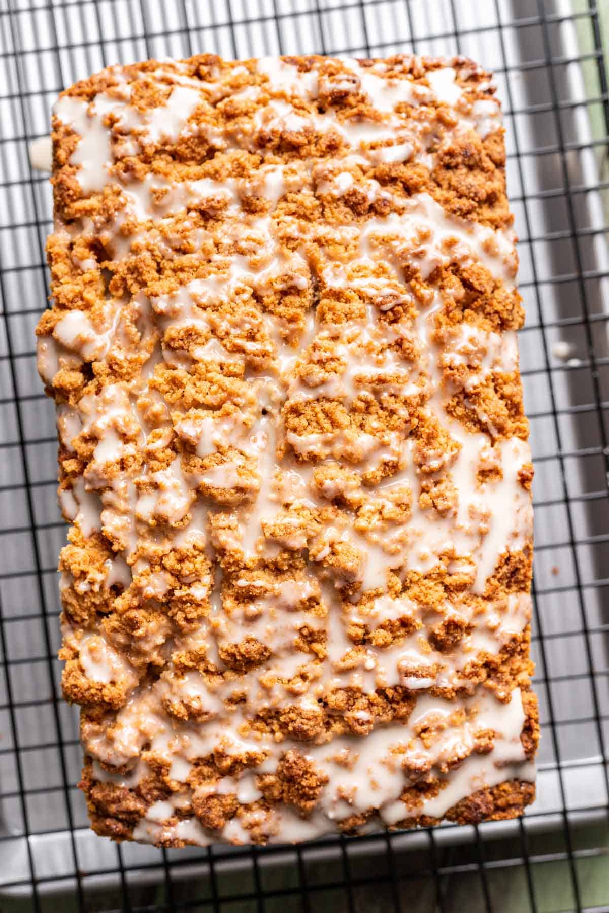 Glaze drizzled on top of apple pumpkin bread.