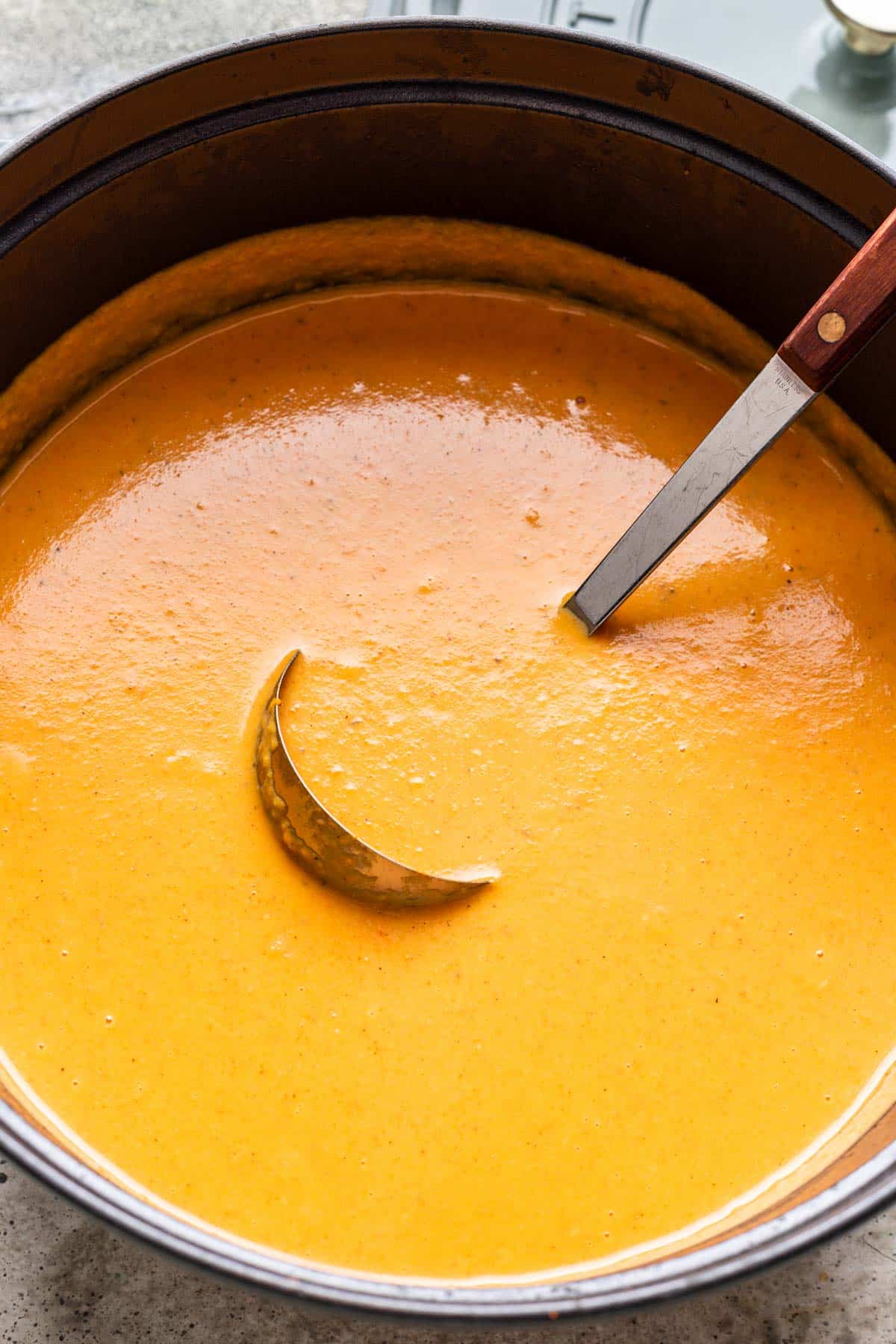 Blended butternut squash and carrot soup in a large pot.