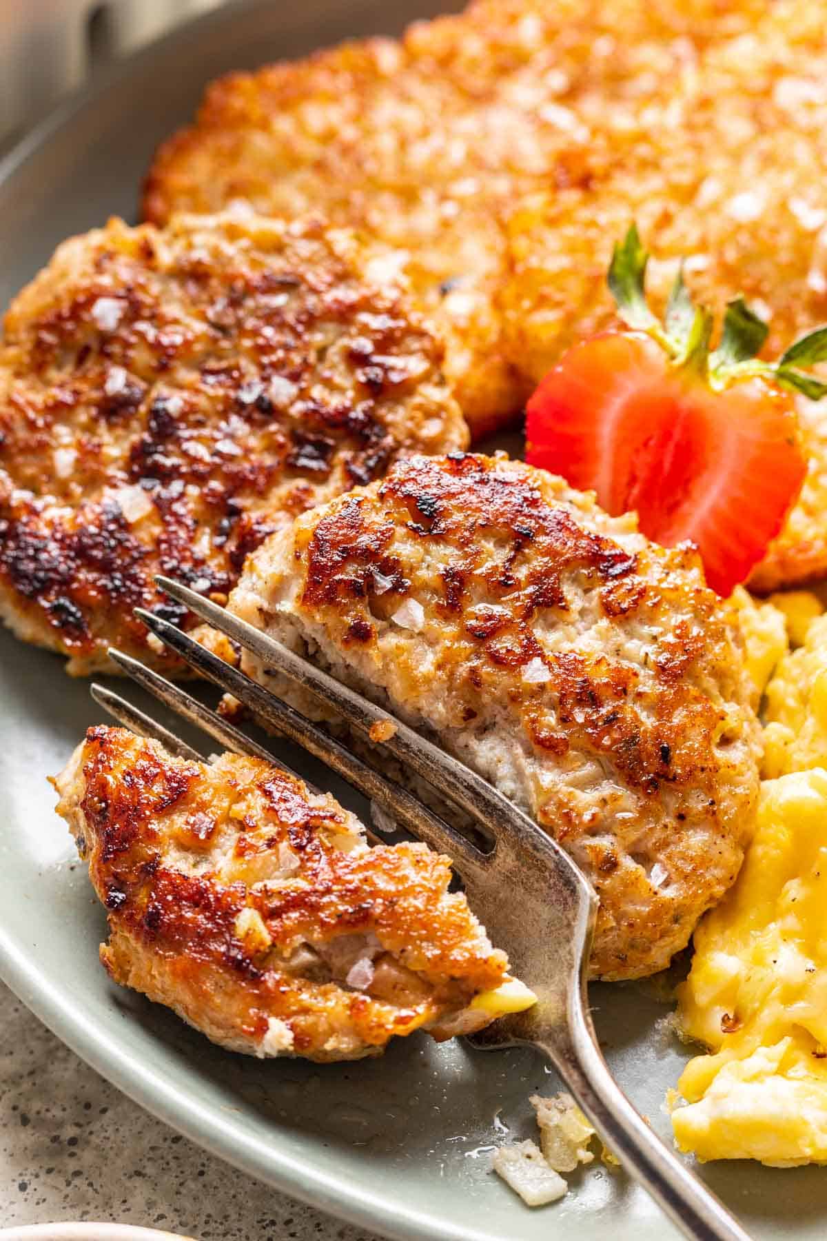 Chicken and apple breakfast sausage cut in half with a fork.