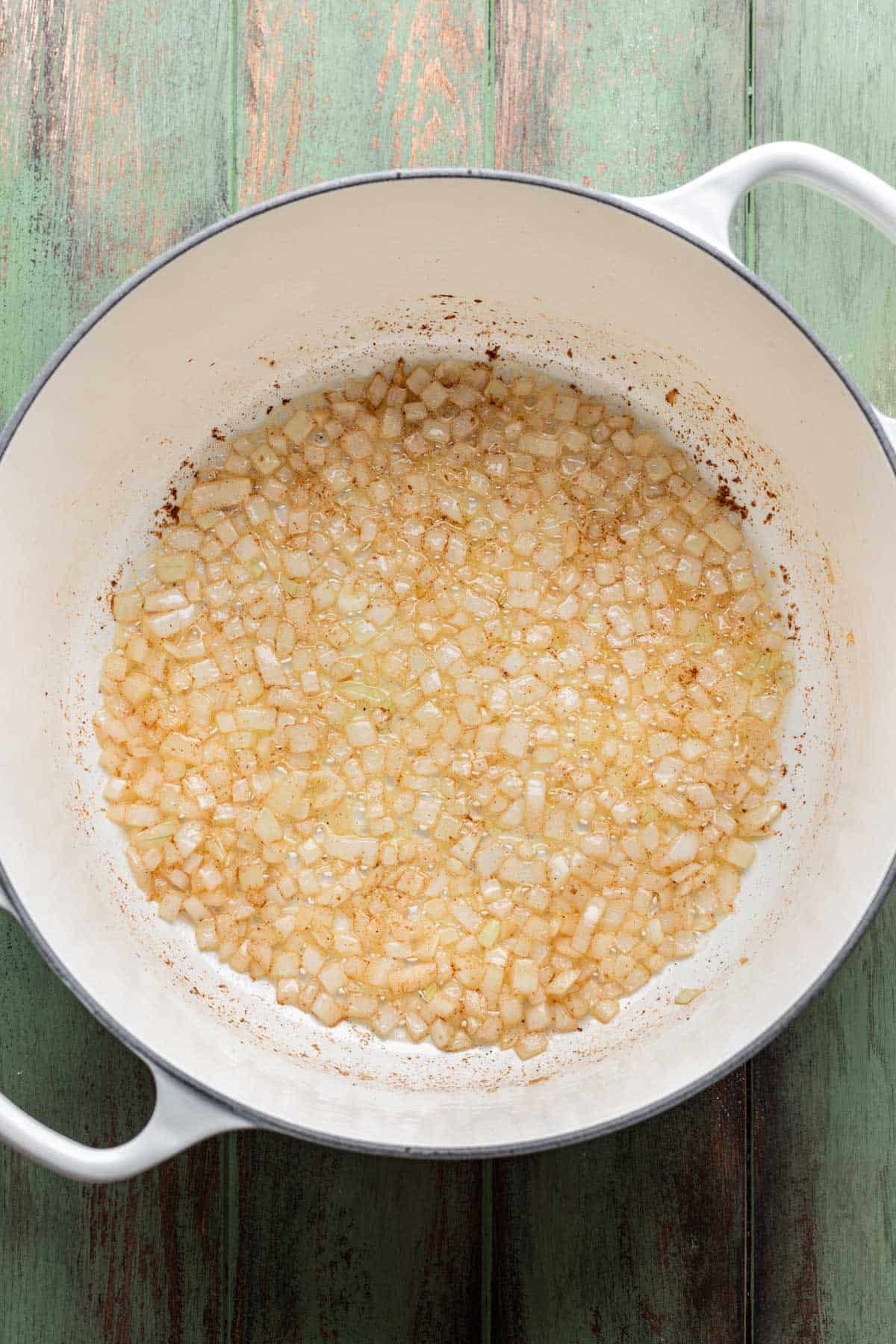 Oil, butter, and onion sautéed in a pot.