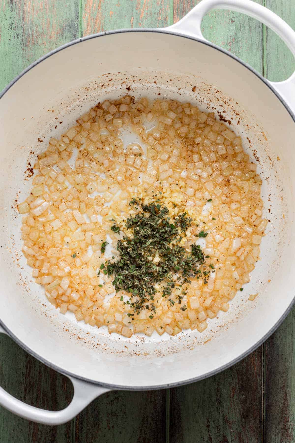 Garlic and chopped sage added to the pot with the onions.