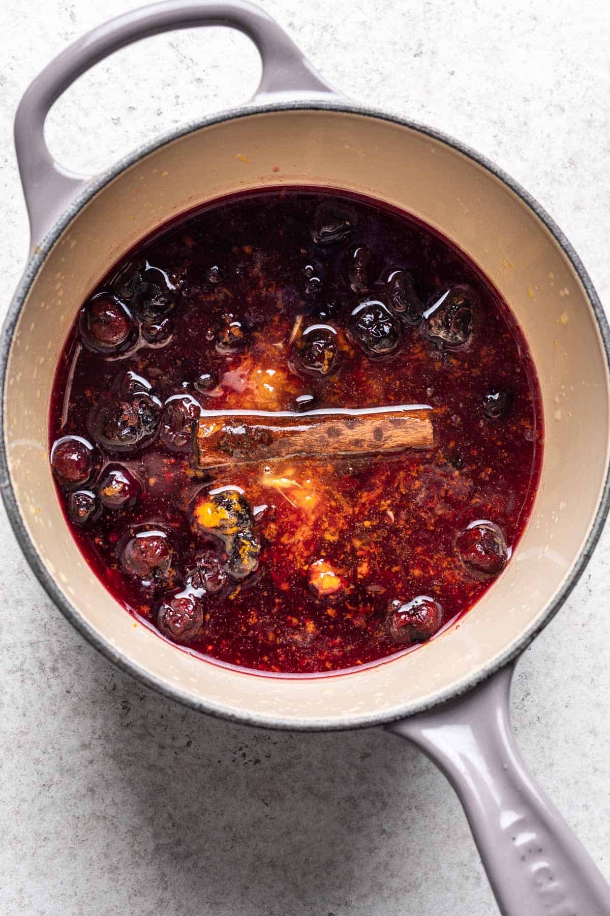 Ingredients for cranberry sauce added to a saucepan.