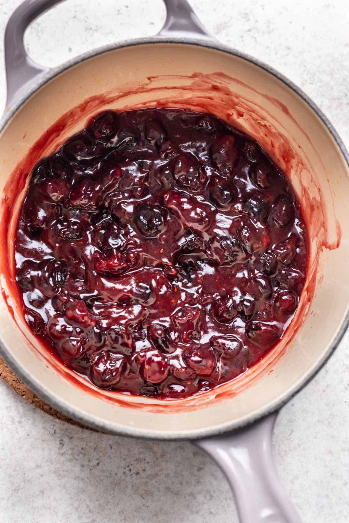Thickened cranberry sauce after cornstarch and water have been added.