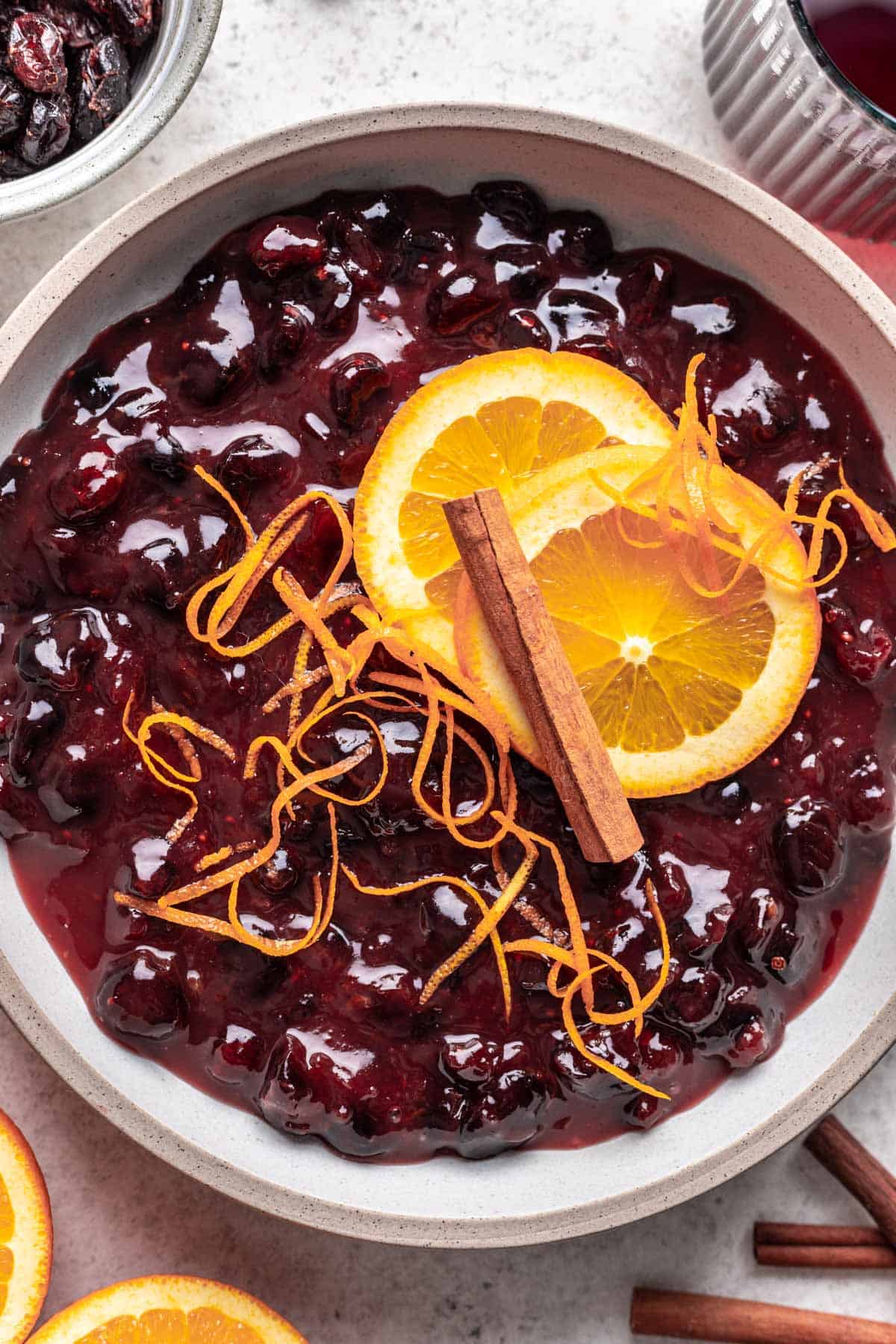 Cranberry sauce with dried cranberries in a white serving bowl.