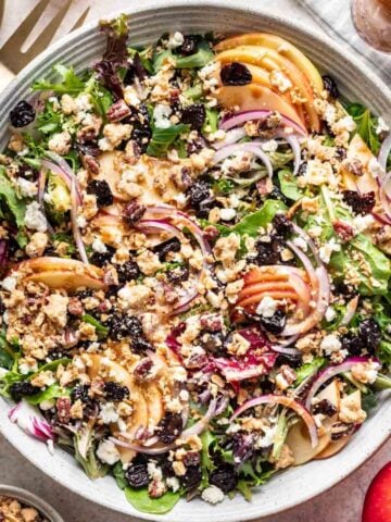 Apple Crisp Michigan Salad with sliced apples, crisp topping, onions, feta, and dried cherries.
