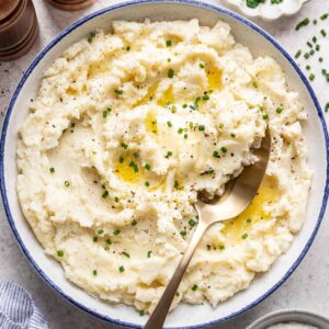 Greek yogurt mashed potatoes in a bowl with a serving spoon.