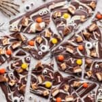 Halloween candy bark with skeleton hands and candy eyes.
