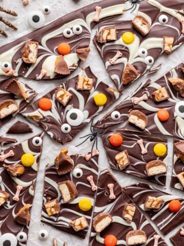Halloween candy bark with skeleton hands and candy eyes.