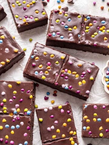 Homemade cosmic brownies on a white backdrop.