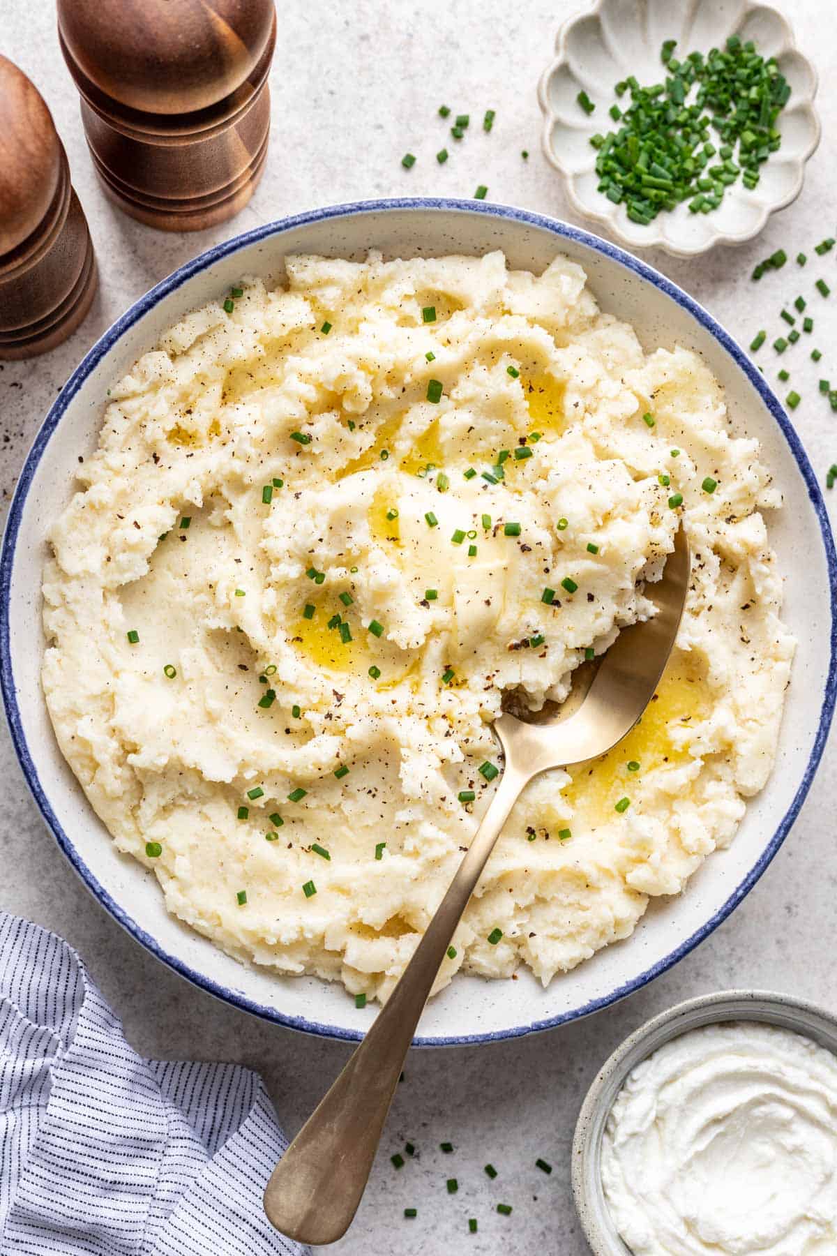 Greek yogurt mashed potatoes in a serving bowl with a serving spoon.