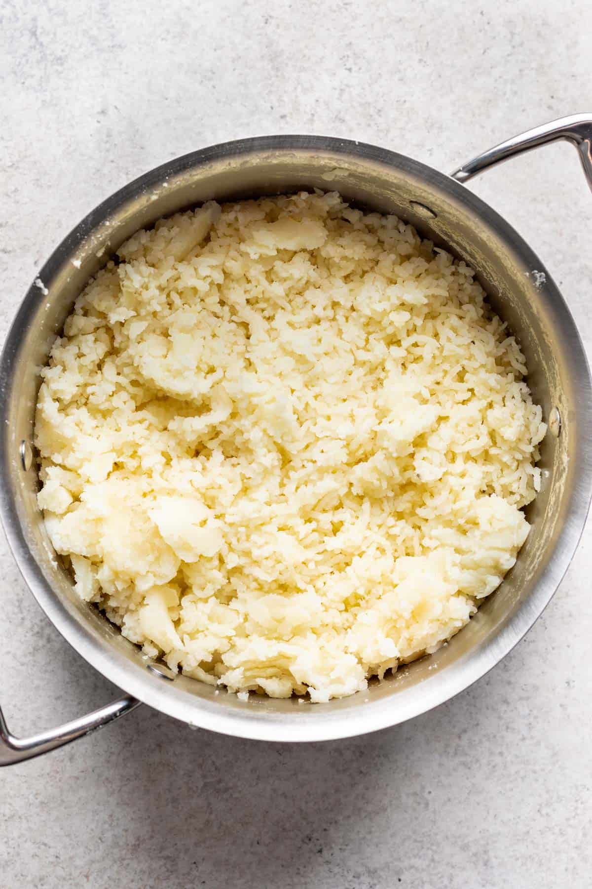 Riced potatoes in a large pot.