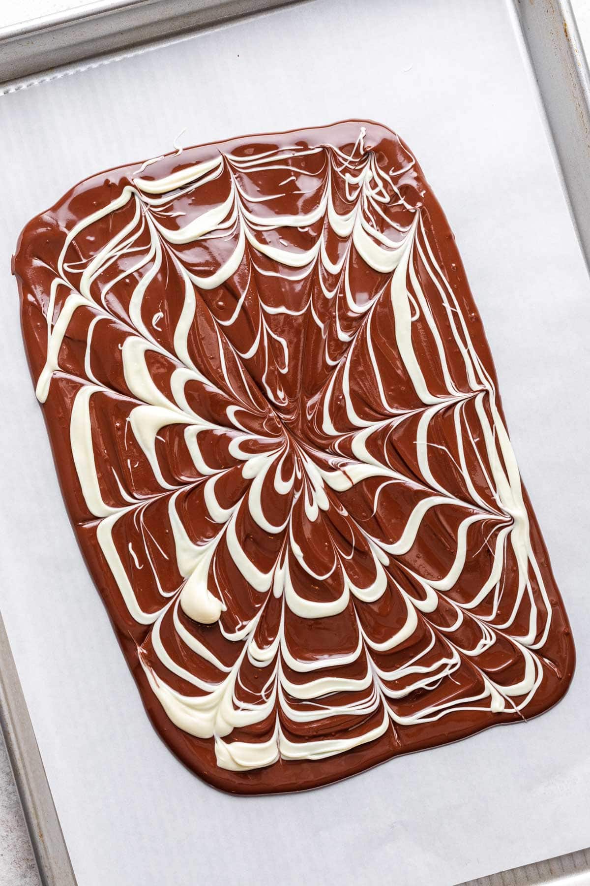 White chocolate drizzled over top and made into a spiderweb shape.