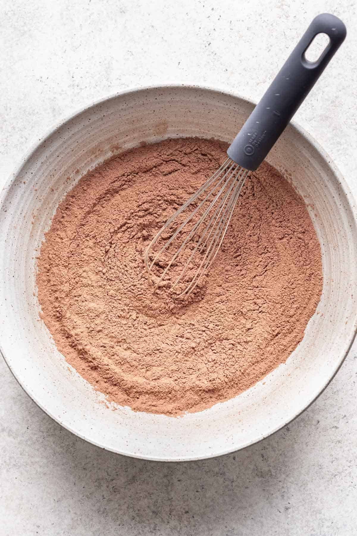 Dry ingredients for cosmic brownies in a mixing bowl.