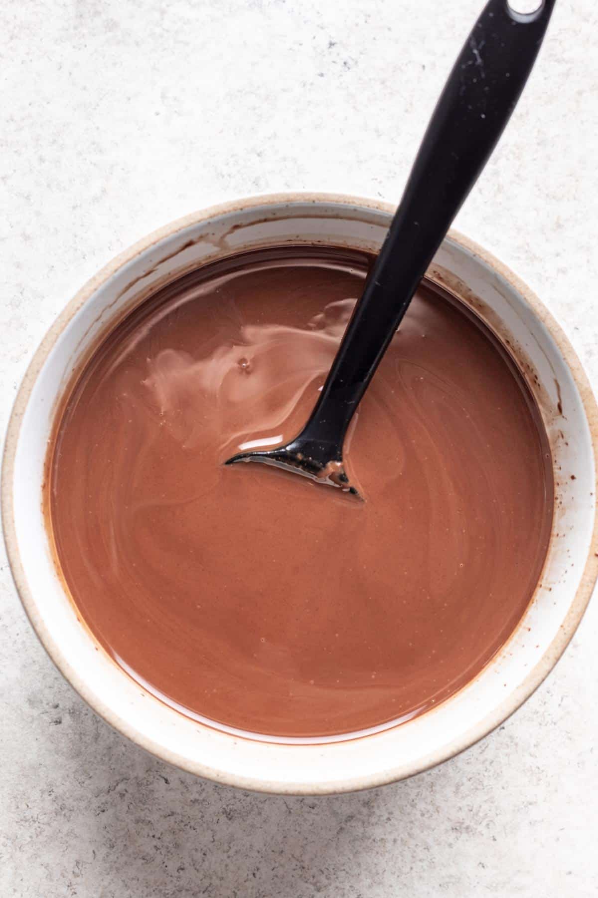 Coconut oil and chocolate chips melted together in a bowl.
