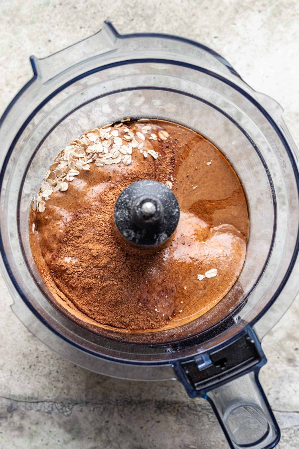 Pumpkin bliss balls ingredients added to a food processor.