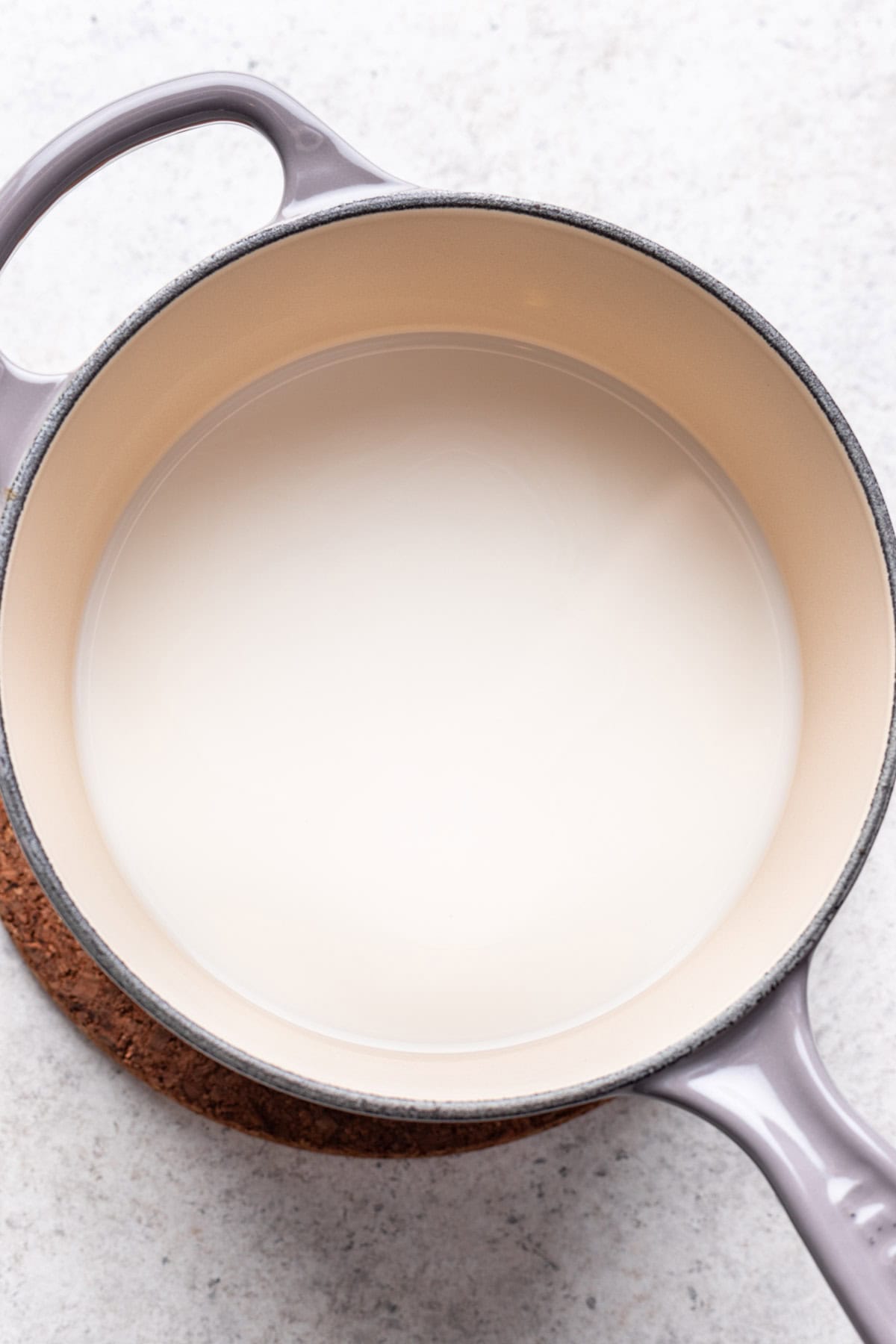 Milk heating in a saucepan.