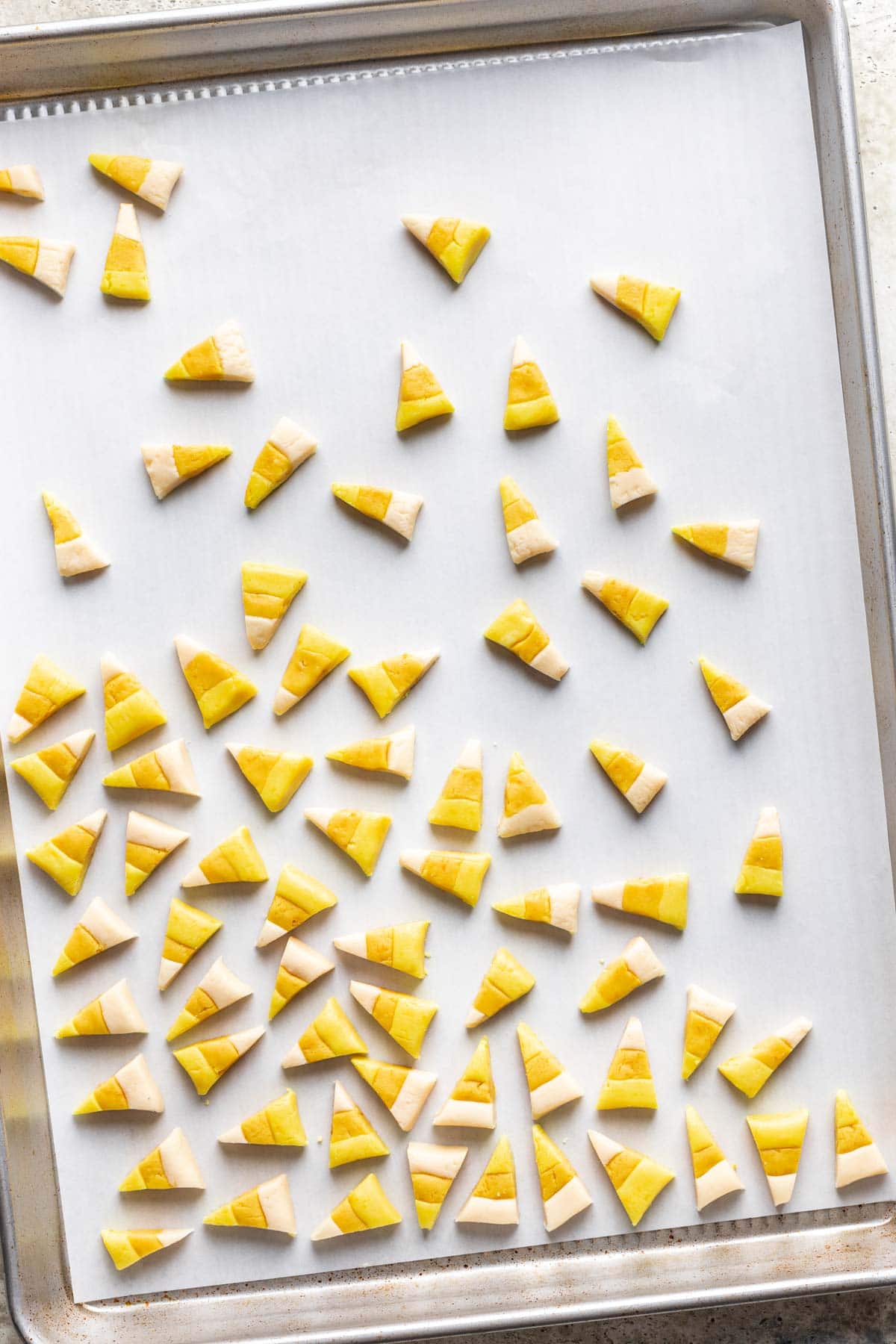 Homemade candy corn drying on a baking sheet.