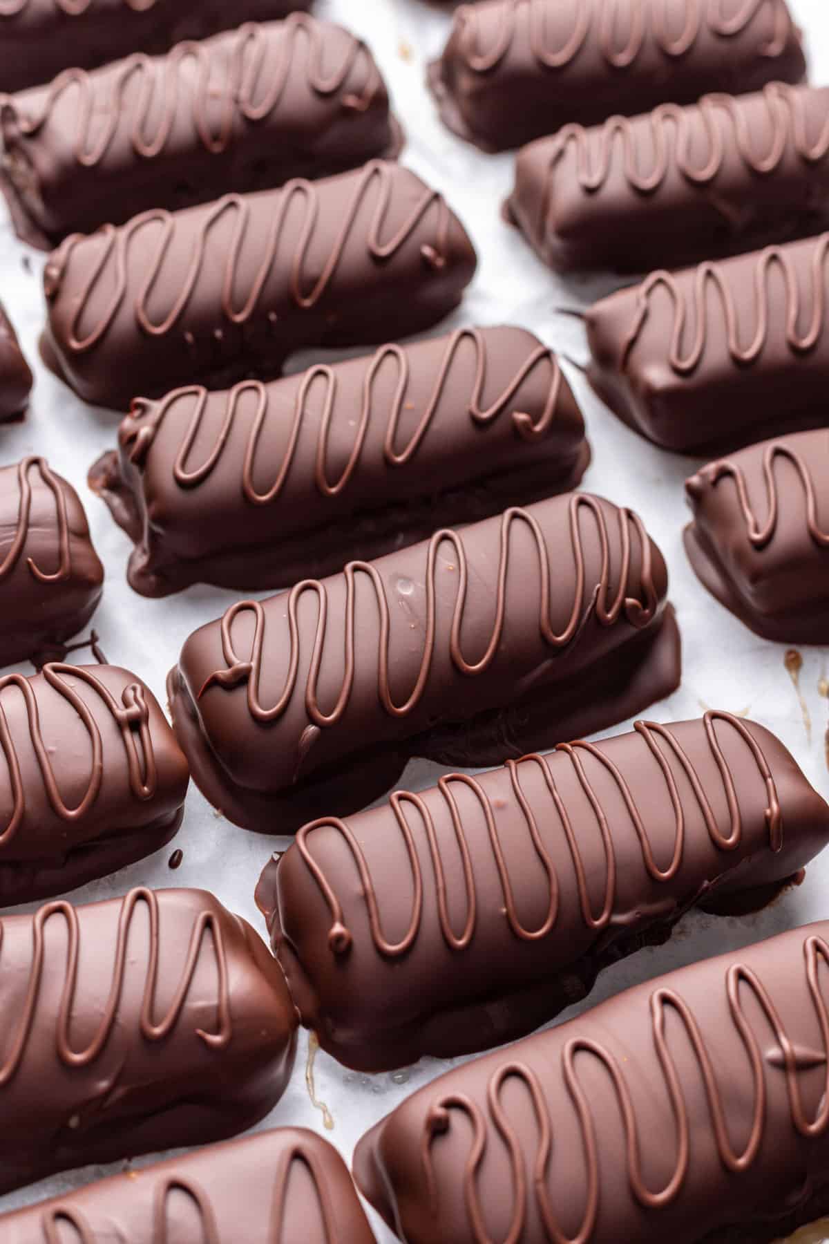 A swirl of melted chocolate added to the top of homemade milky way bars.