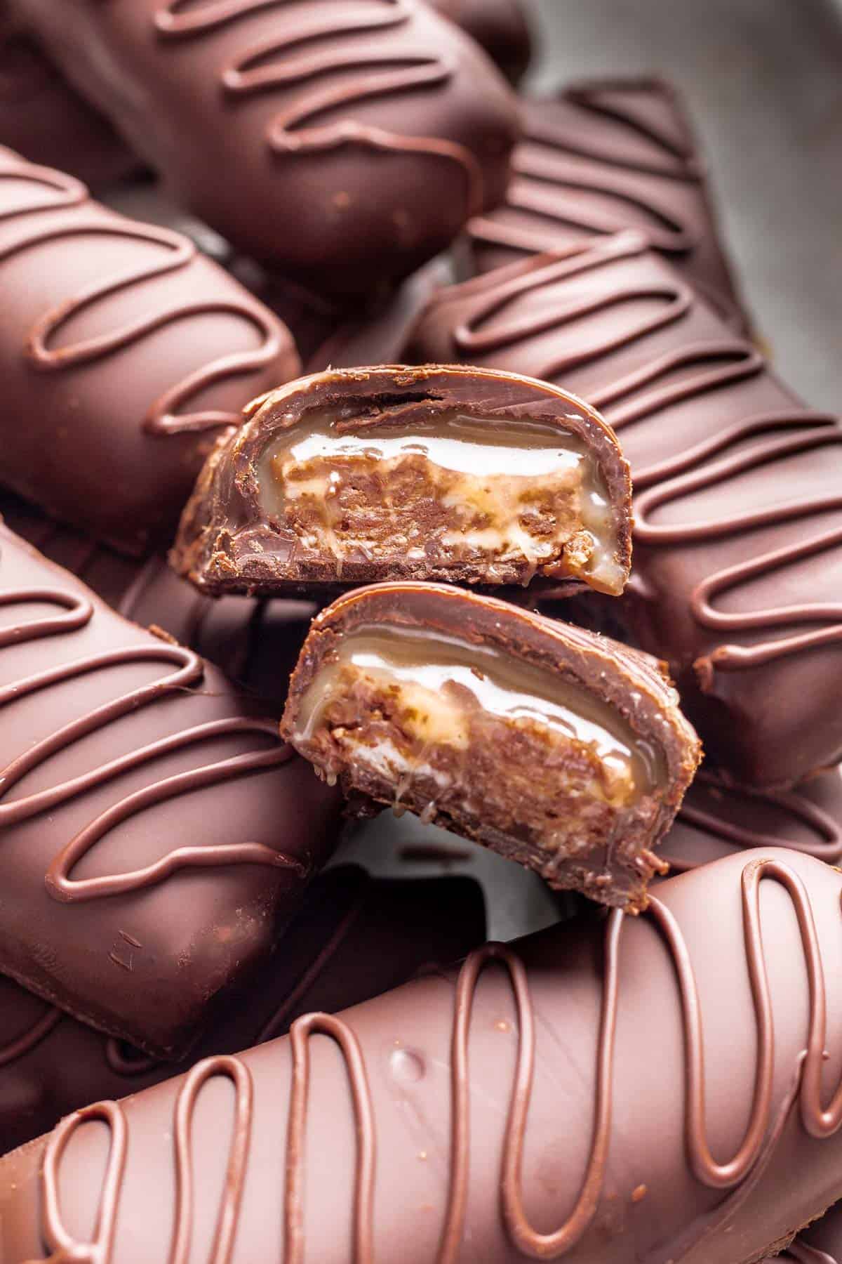 Homemade milky ways sliced to show the nougat and caramel filling in the middle.