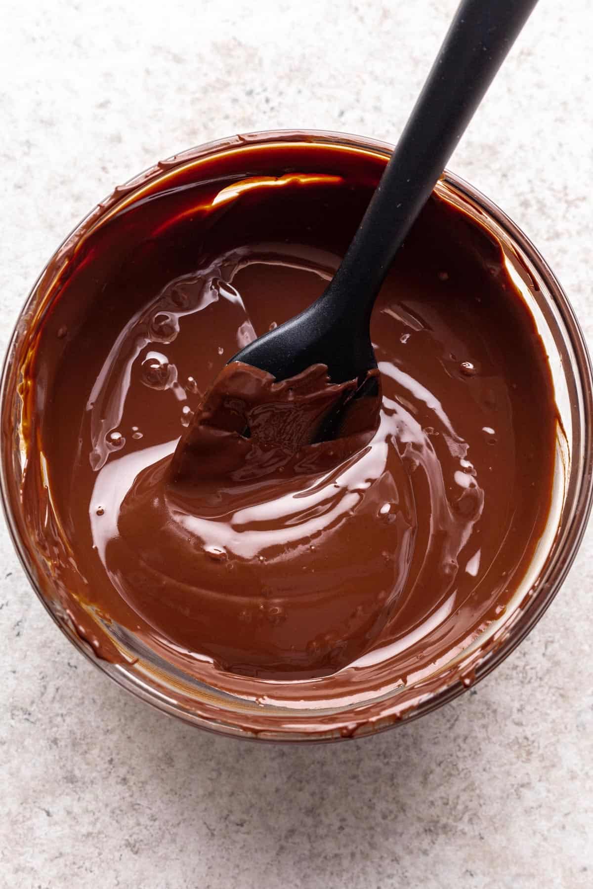 Melted chocolate in a glass bowl.