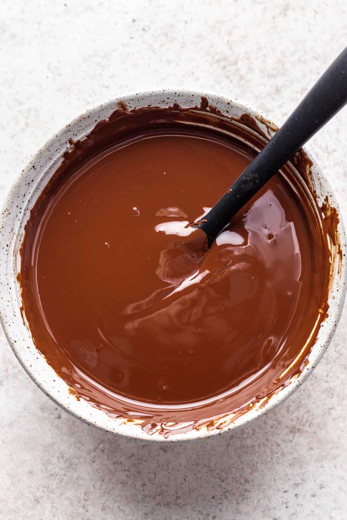 Melted chocolate in a ceramic bowl.