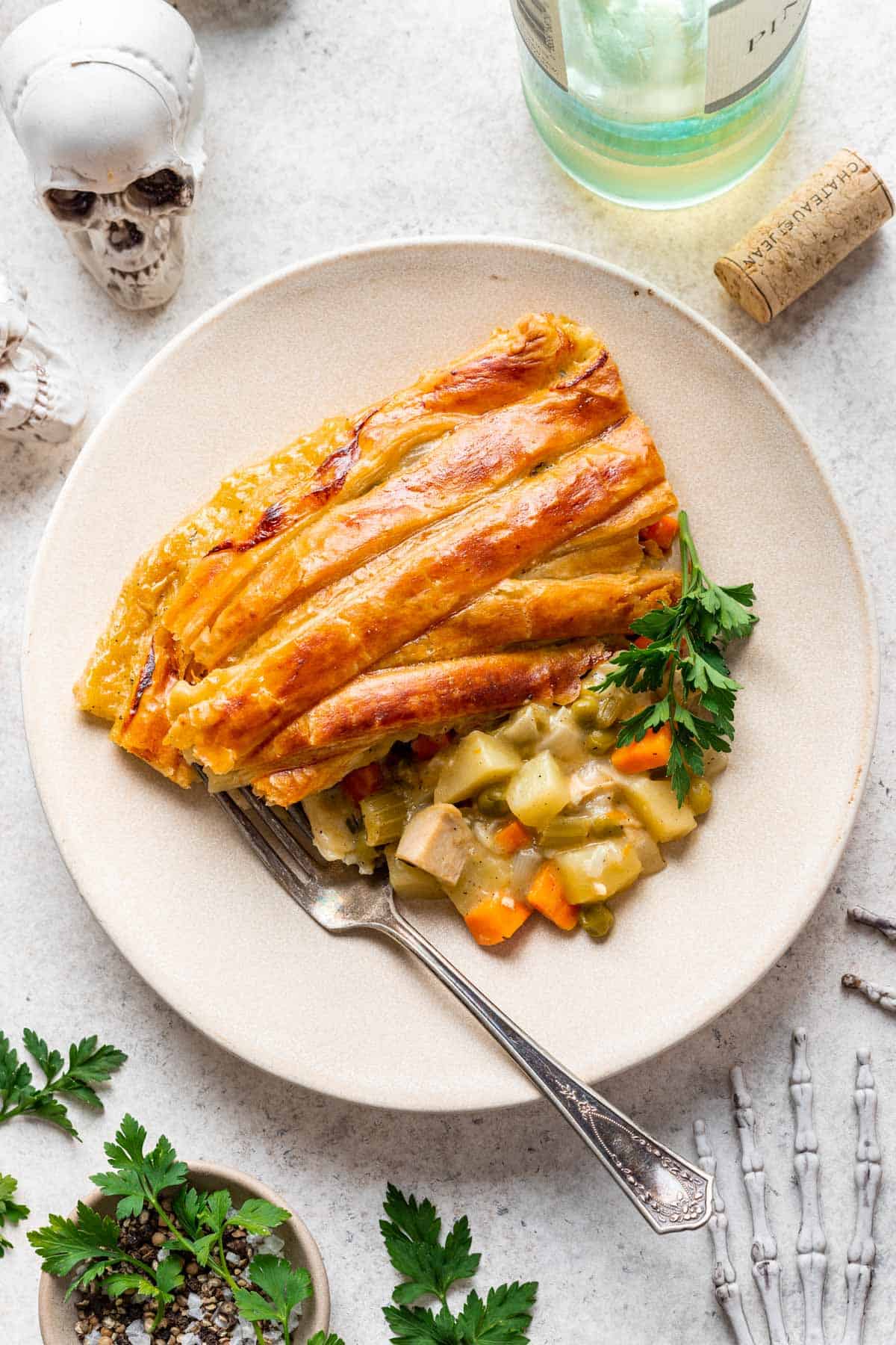 A slice of mummy chicken pot pie on a beige plate.