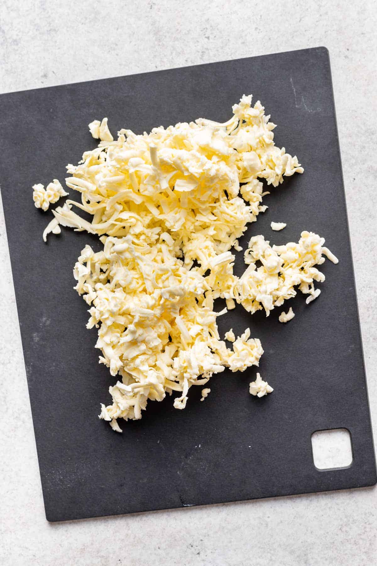 Grated butter on a cutting board.