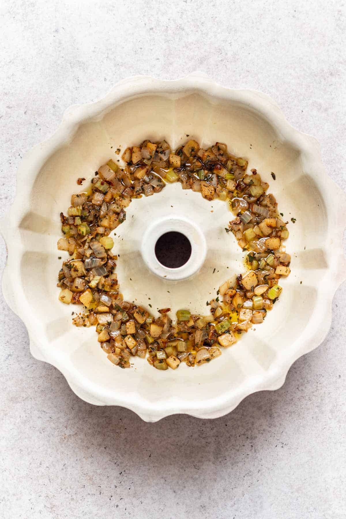 Stuffing vegetables layered on the bottom of a bundt pan.