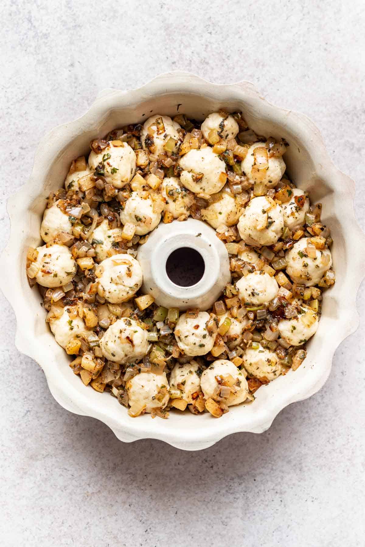Biscuit dough rolled into balls and layered with sautéed vegetables in a bundt pan.