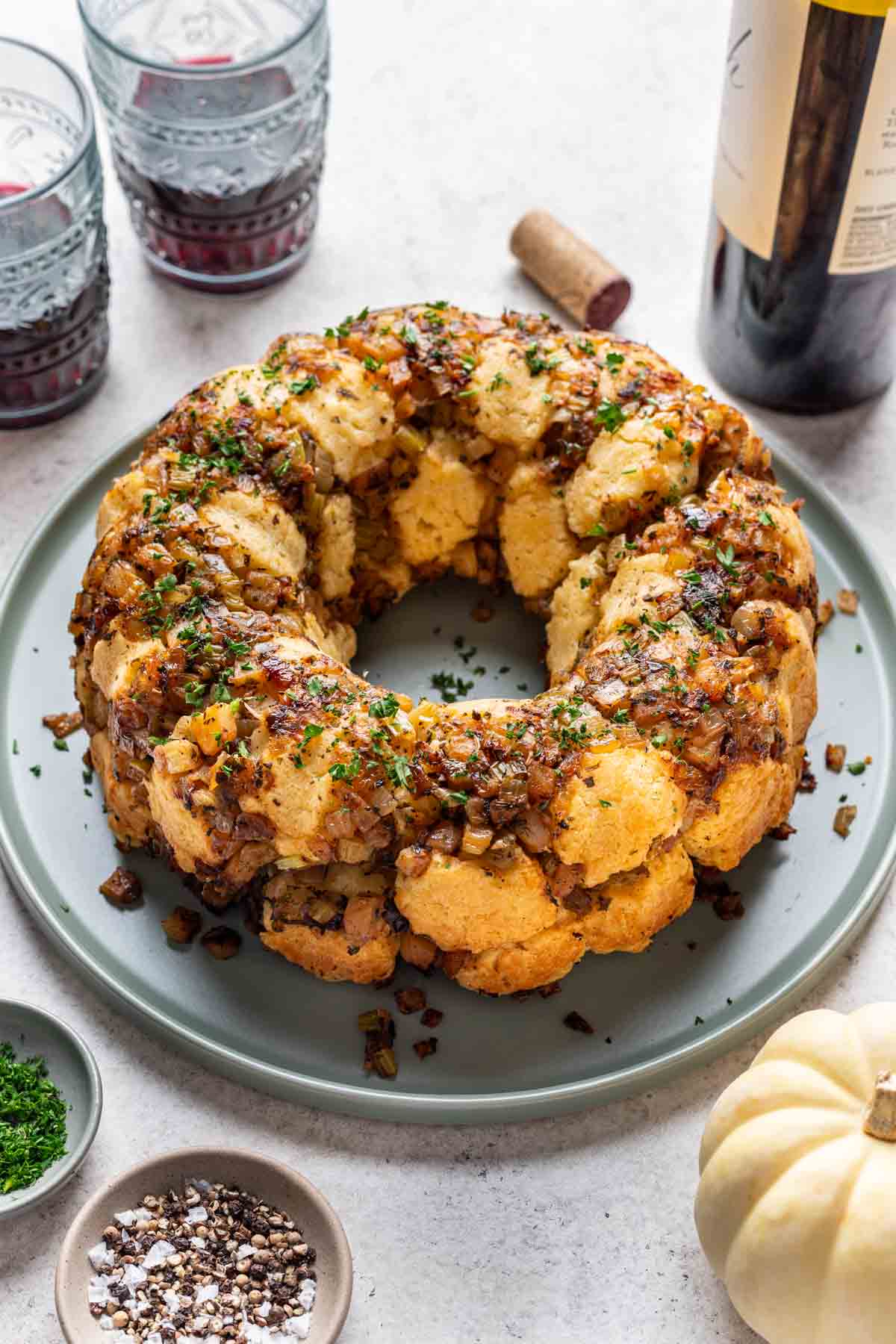 Thanksgiving stuffing monkey bread on a platter with red wine served on the side.