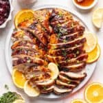 Sliced honey baked turkey breast on a serving platter.