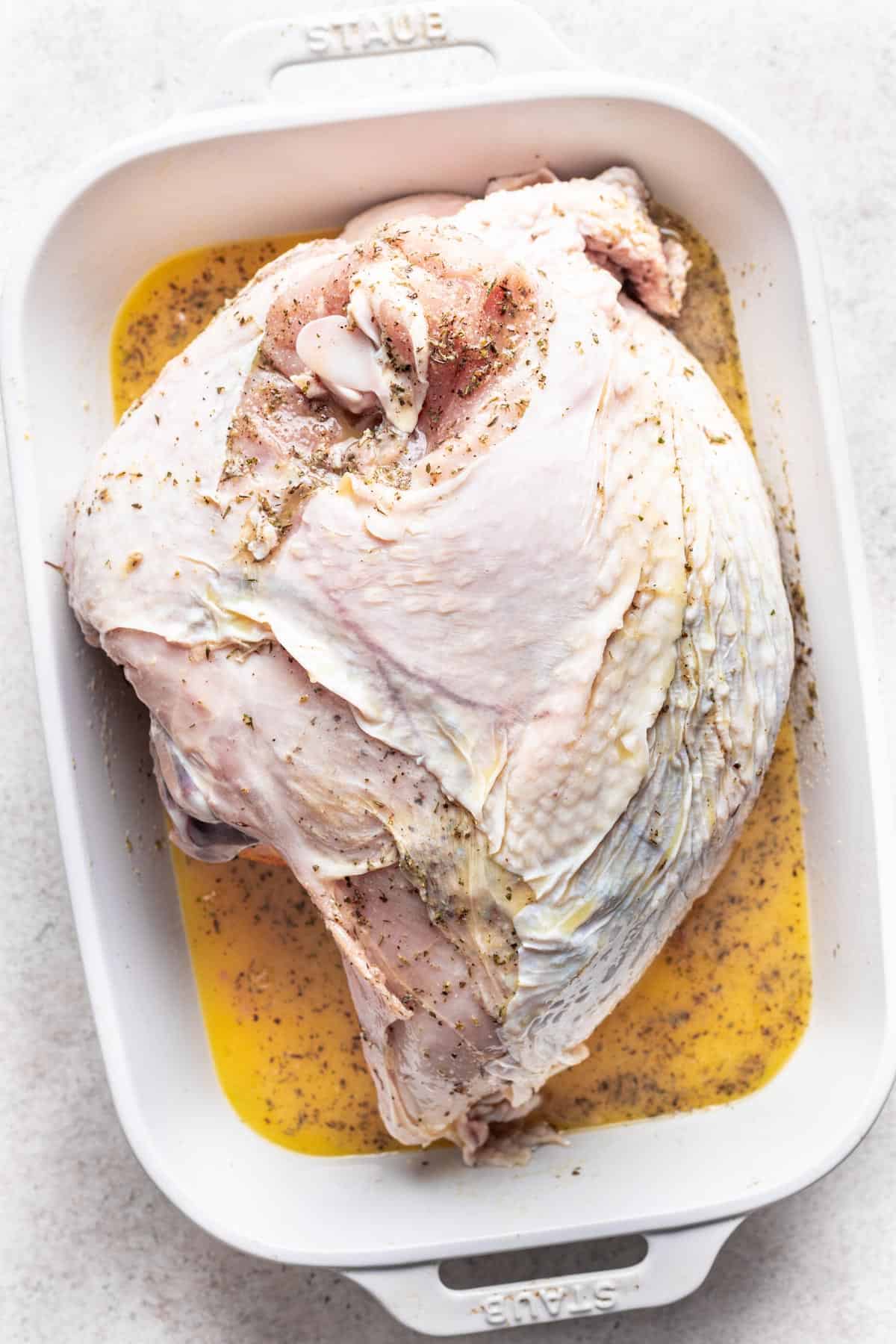 Orange juice poured over the raw turkey breast.