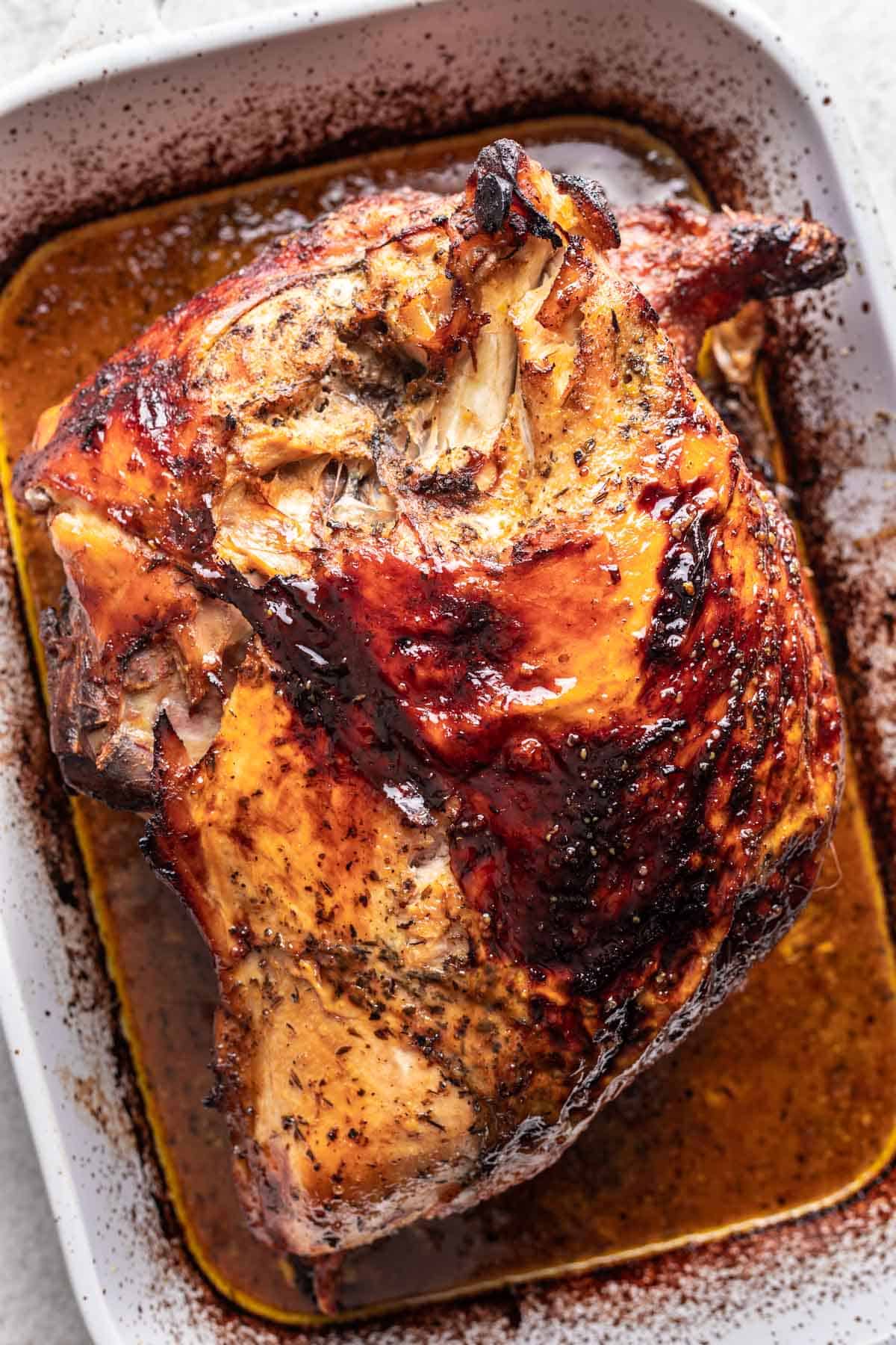 Honey glazed turkey breast in a baking dish.