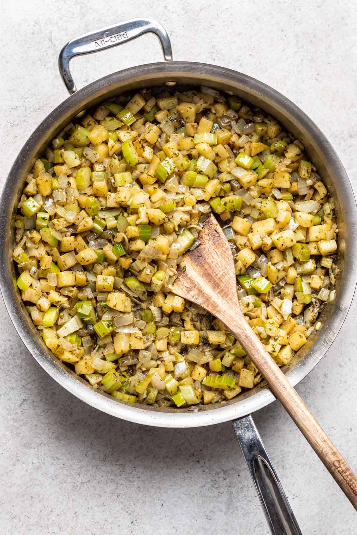 Sautéed stuffing vegetables and apple in a large skillet.
