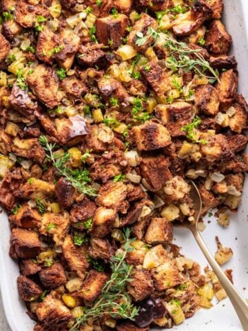 Challah bread stuffing in a white baking dish.