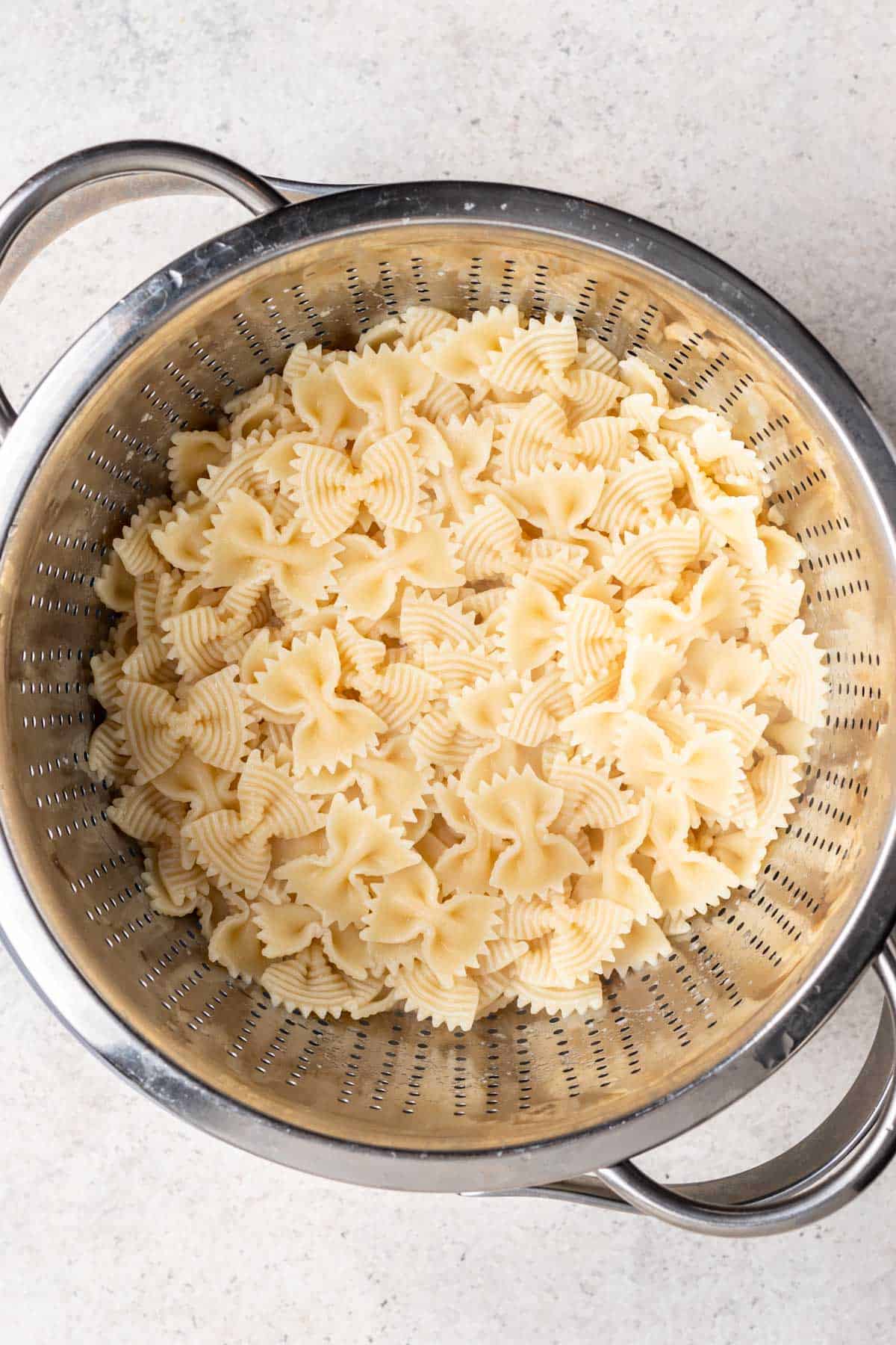 Cooked and drained pasta in a colander.