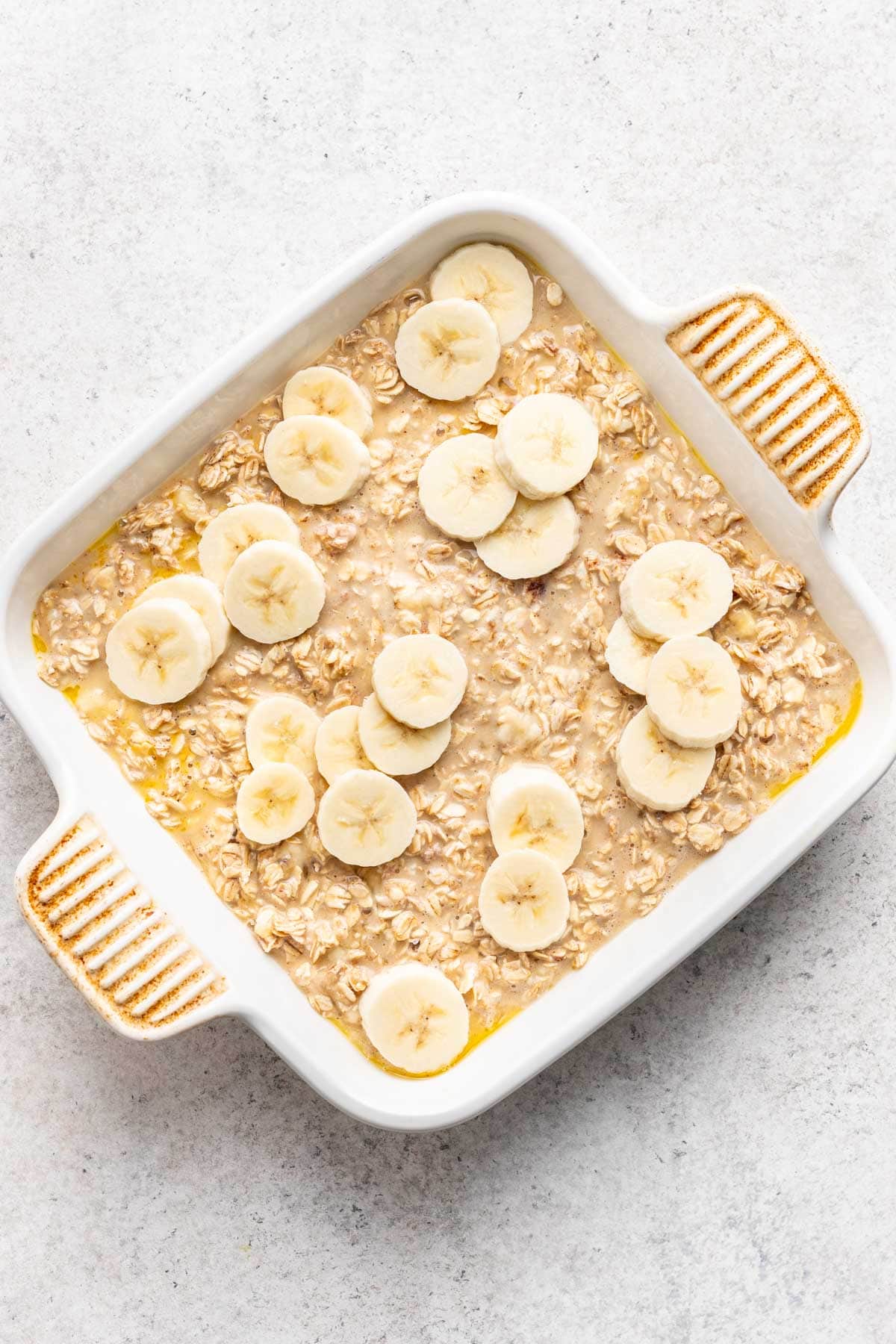 Banana bread baked oats in a baking dish before baking.