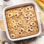 Banana bread baked oats in a white baking dish.