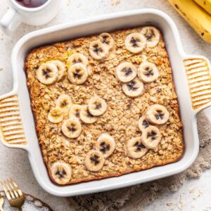 Banana bread baked oats in a white baking dish.