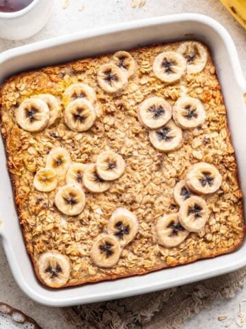 Banana bread baked oats in a white baking dish.