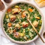 Instant pot Italian wedding soup in a white bowl with a spoon.
