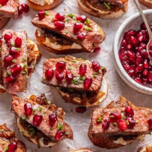 Steak and whipped feta crostini topped with fresh chives and pomegranate seeds.